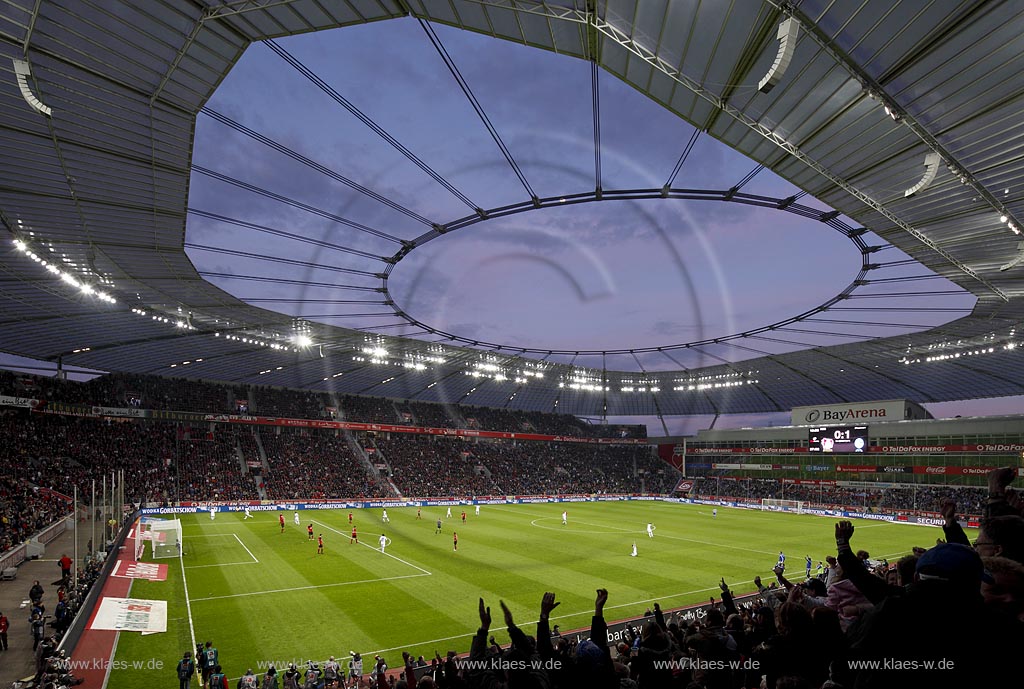Leverkusen Bayarena in abendlicher Beleuchtung waehrend einem Fussballspiel von Bayer 04 Leverkusen gegen FC Schalke 04 mit Fans, blaue Stunde, von der Abendsonne, angestrahlte Wolken; Leverkusen footballstadium Bayarena, match between Bayer 04 Leverkusen and  FC Schalke 04 during blue hour with Moon