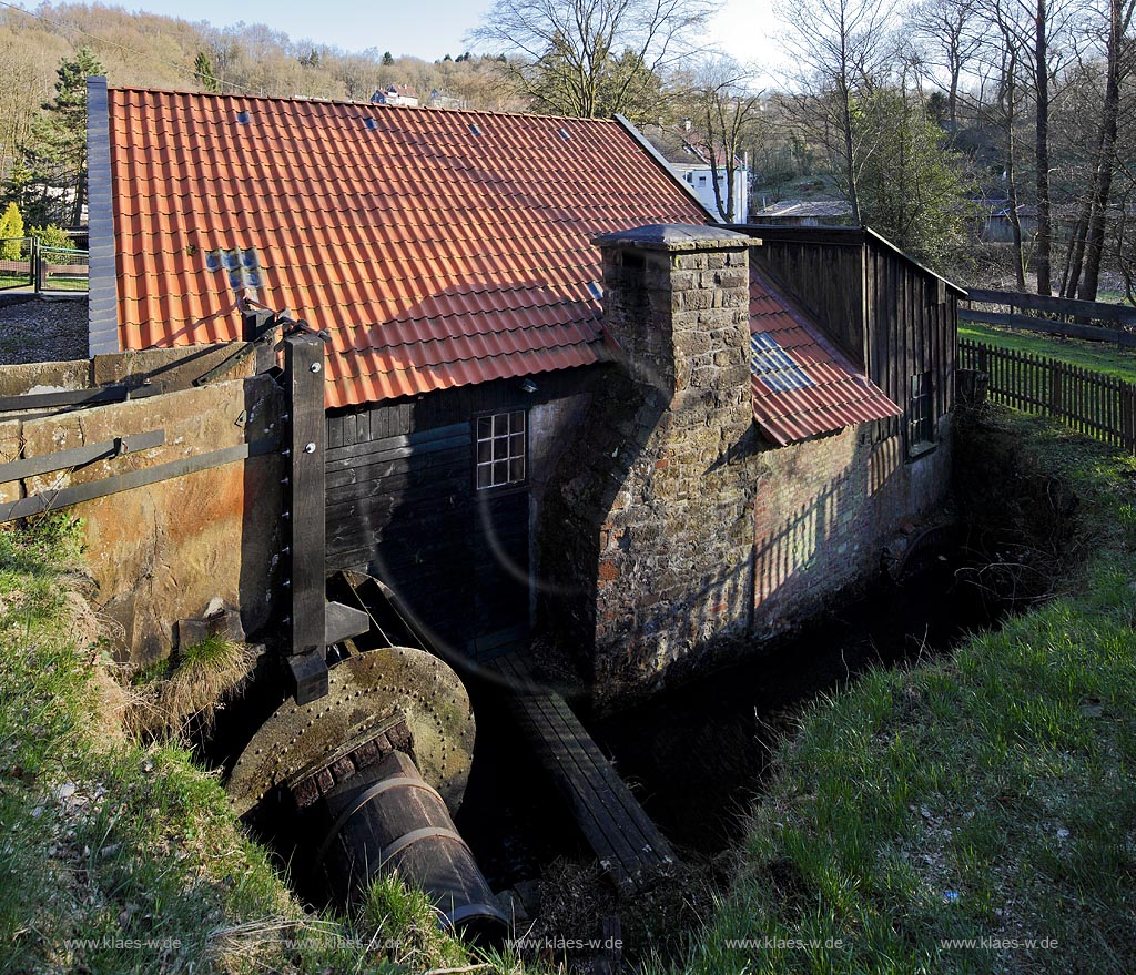 Remscheid Steffenshammer, der historische Clemenshammer im Gelpetal im Fruehling stimmungsvoll von der Abendsonne beleuchtet, Blick auf das Wasserrad und den Kamin; Remscheid Steffenshammer the historical Clemenshammer in springtime with water wheel