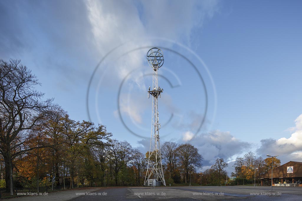 Remscheid Bliedinghausen, Mannesmann-Turm, ueber einem dreieckigen Grundriss steigen drei sparsam dimensionierte Stahlrohre konkav. einige zogen nach oben auf, um sich in der Hoehe in die doppelte Kreisform des Markenzeichens "MW" auf den geringsten Abstand voneinander zu vereinigen. Regelmaessige Diagonal-Roehrenstreben fuellen diese Umrissgestalt ueber den Kreuzverbaenden des Sockelteils stabilisierend aus. Der Werbepylon ist am hoechsten Punkt 59 Meter hoch und wurde am 21.08.1961 in Betrieb genommen. Nach gegenwaertigem Kenntnisstand ist der Remscheider Turm das letzte nordrhein-westfaelische Beispiel seines Typs. Heute dient der Turm unter anderem als Sendemastanlage.Der an der Burger Strasse stehende "Mannesmann-Turm" wurde am 04.09.2002 in die Denkmalliste der Stadt Remscheid eingetragen; Remscheid Bliedinghausen, tower Mannesmann-Turm.