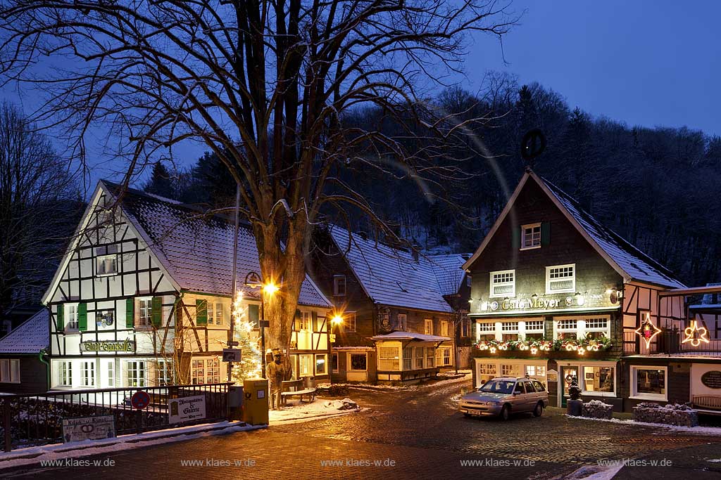 Solingen-Burg, Unterburg Weihnachtliche Stimmung zur blauen Stunde, beleuchteter Weihnachtsbaum, Fachwerkhaus alte Sparkasse, illuminiert davor der Burger Brezelbaecker, rechts das verschieferte Cafe Meye rmit Burger Brezel auf dem Giebel; Solingen Burg, village Unterburg during Christmas time with Christmas tree and old half timbered bankhouse Sparkasse, pretzel baker and cafe Meyer, illuminated