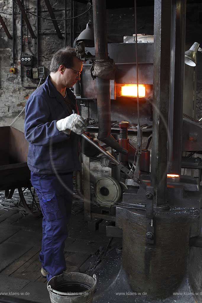 Solingen Merscheid, LVR-Industriemuseum, Rheinisches Landesmuseum fr Industrie- und Sozialgeschichte, Gesenkschmiede Hendrichs, Arbeiter demonstriert das Schmieden an einem Schmiedeofen und mit einem Schmiedehammer; museum of  industry and social history, an  employee shows how to forge at a forging furnace and with a hammer 