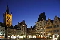 Trier Hauptmarkt mit St. Gangolf Kichturm, Marktkreuz und Steipe zur blauen Stunde in Kunstlichbeleuchtung, illuminiert; Trier market with St. Gangolf church in night or evening image with illumination