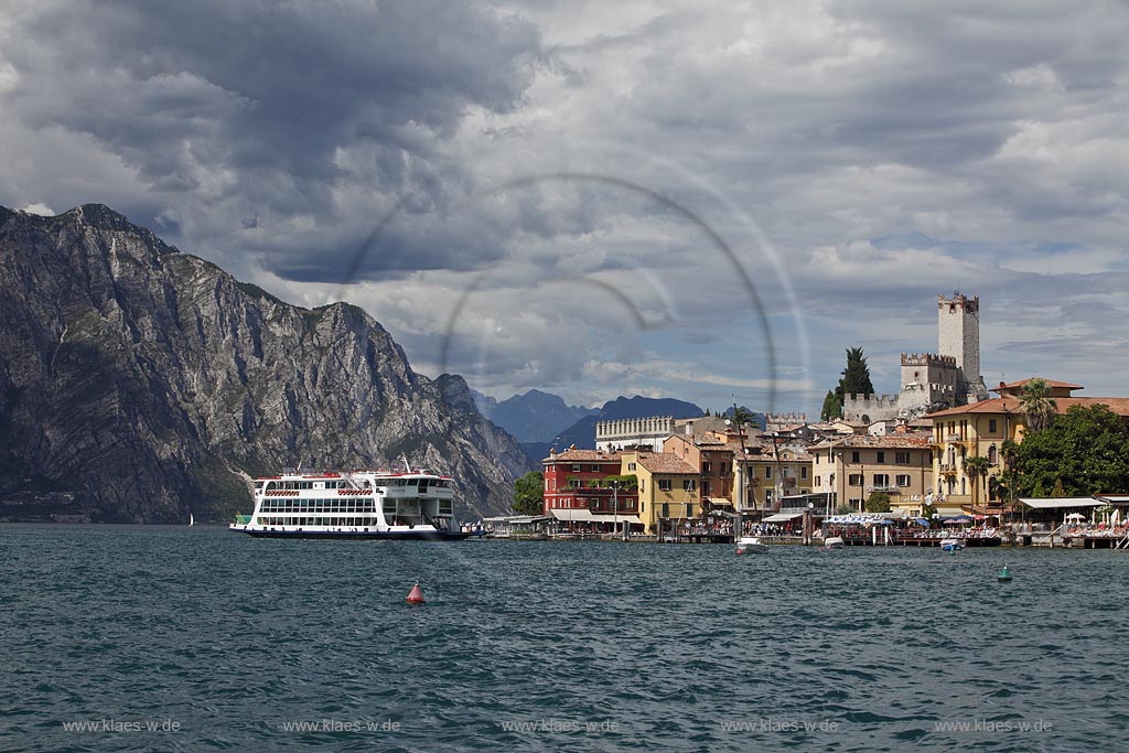 Malcesine, Panoramablick vom Gardasee auf den Ort mit Scaligerburg, Hafen und Faehrschiff Tonale der Schifffahrtsgesellschaft Navigarda, Seeseite; Malcesine, panorama view from Lake Garda to the seafront of Malcesine with Scaliger castle, port and ferryboat Tonale