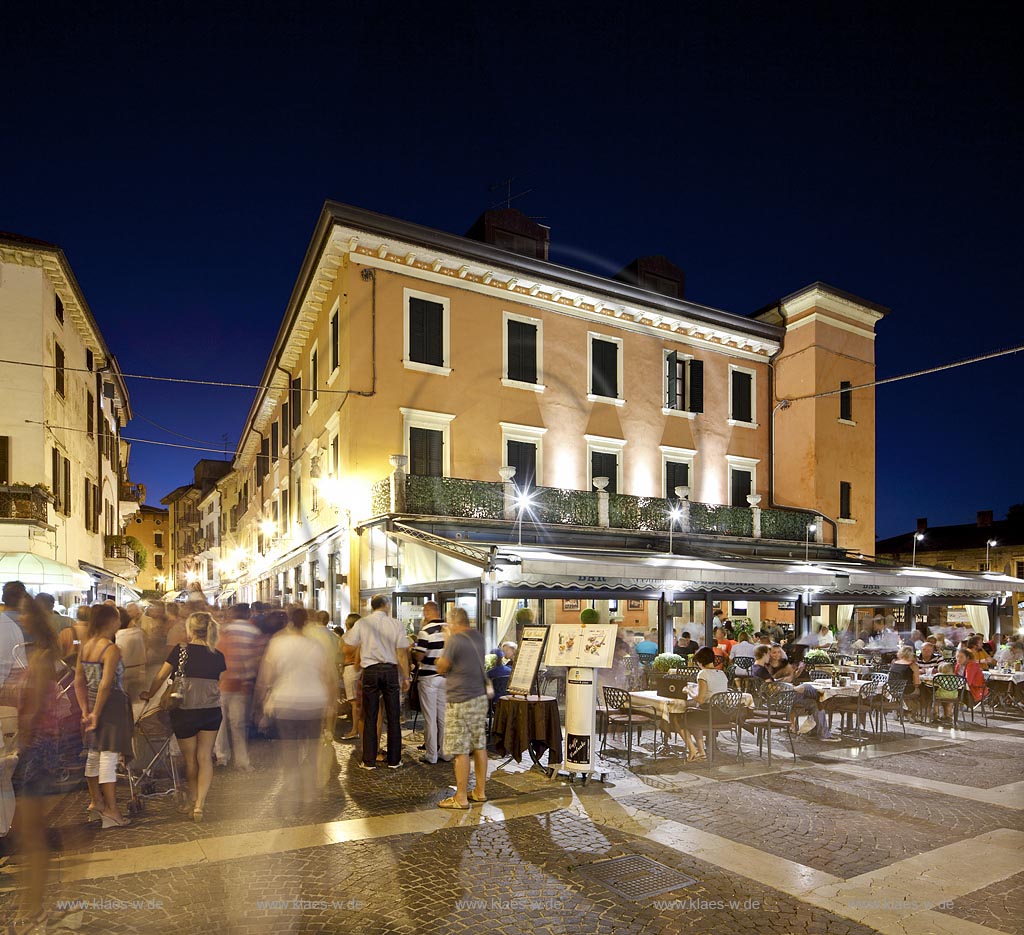Peschiera, Nachtleben in der Altstadt mit Bar, Pizzeria, Retaurant, Gelateria, Menschen; Peschiera, Nightlife with  a restaurant, bar, pizzeria, humans on a place in the old town