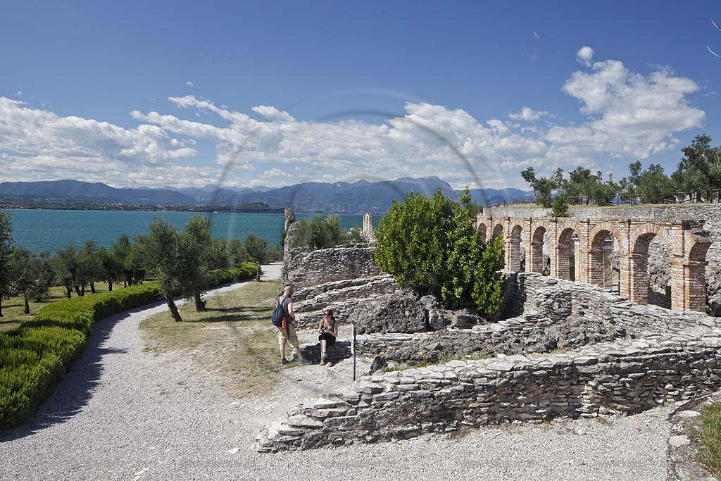 Sirmione, die Grotten des Katull, imposante Ueberreste einer roemischen Villa  aus dem 1. Jahrhundert vor Christi, Landschaft mit Ruinen, mit Gardasee und Bergen im Hintergrund; Sirmione, the Caves of Catullus, impressive remains of a Roman villa, 1th Century A.D. landscape with Lake Garda and mountains in the background; Sirmione Le Grotte di Catullo, imponenti resti una villa romana 1 sec. d.C.