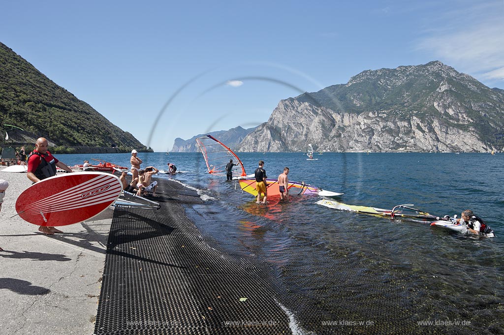 Torbole sul Garda, Circolo Velo Torbole, Blick ueber den Gardasee mit Surfern und  Bergkulisse im Hintergrund, tuerkis schimmernde Wasseroberflaeche, windig; Torbole sul Garda, Circolo Velo Torbole, view over the Lake Garda with wind surfers and mountains in the background, windy
