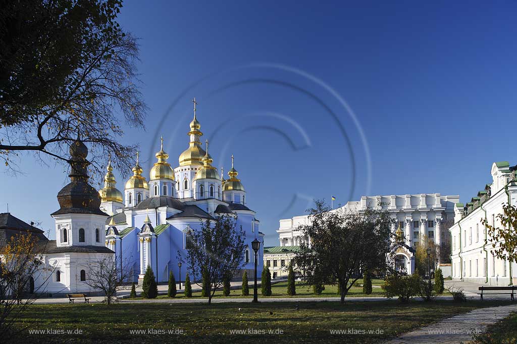 Kiew im Klostergarten des  Michaelskloster Mychajlivs'kyj Zolotoverchyj monasty mit dem Kloster mit den goldenen Kuppeln, der Kirche mit Refektorium vorne links und dem Gebauede des Auswaertigen Amtes auswrtiges Amt, Ministerium fur auswaertige Angelegenheiten der Ukraine hinten rechts. Ukrainischer Barock. The St. Michael monastery, also spelled St. Michail's, mainly painted azure with a few golden domes on top of it