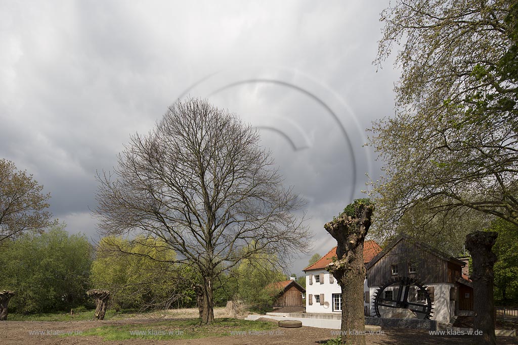 Moers, die umgebaute und restaurierte Aumuehle, auch Obere Wassermuehle im Fruehling mit Wolkenstimmung; Moers mill Aumuehle in springtime with atmospheric clouds.