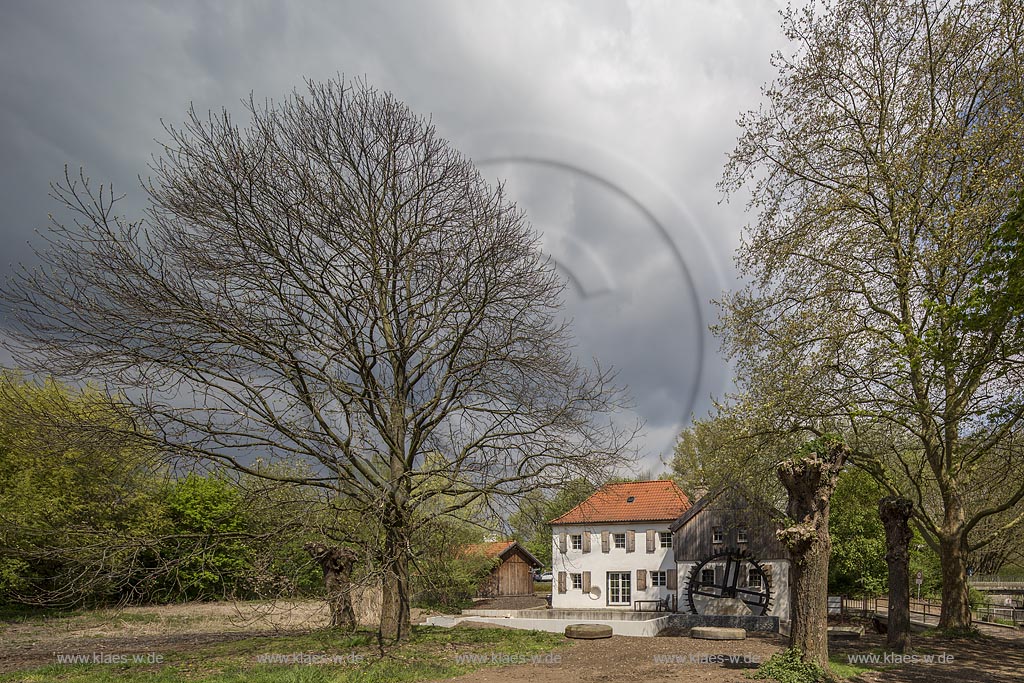 Moers, die umgebaute und restaurierte Aumuehle, auch Obere Wassermuehle im Fruehling mit Wolkenstimmung; Moers mill Aumuehle in springtime with atmospheric clouds.