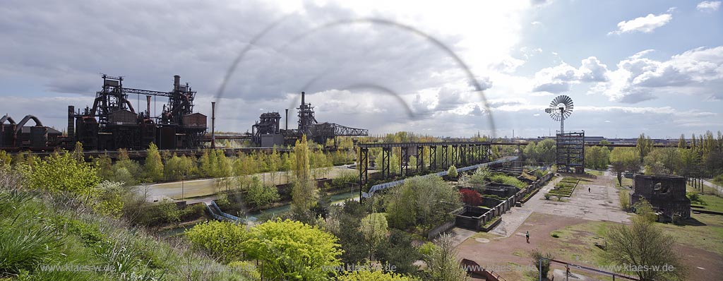 Duisburg Meiderich. Panoramablick mit Hochofen 1, 2 und 5, Erzbunker, Bock-Kran, Bunkeranlage, Windenergieturm, Sintergaerten, Sinterplatz. Der Landschaftspark Duisburg-Nord, auch kurz LaPaDu ist ein etwa 200 Hektar groer Landschaftspark rund um ein stillgelegtes Huettenwerk in Duisburg-Meiderich, das im Rahmen der IBA (Internationale Bauausstellung Emscher Park) entstand. Der Landschaftspark ist einer der Ankerpunkte der Europaeischen Route der Industriekultur sowie der Route der Industriekultur im Ruhrgebiet;  Duisburg-Meiderich, the Meiderich ironworks are the main feature in the North Duisburg Landscape Park, panorama view from blast furnace at left side to the wind turbine tower at right sidem sintering plant. Duisburg Meiderich. Panoramablick mit Hochofen 1, 2 und 5, Erzbunker, Bock-Kran, Bunkeranlage, Windenergieturm, Sintergaerten, Sinterplatz. Der Landschaftspark Duisburg-Nord, auch kurz LaPaDu ist ein etwa 200 Hektar groer Landschaftspark rund um ein stillgelegtes Huettenwerk in Duisburg-Meiderich, das im Rahmen der IBA (Internationale Bauausstellung Emscher Park) entstand. Der Landschaftspark ist einer der Ankerpunkte der Europaeischen Route der Industriekultur sowie der Route der Industriekultur im Ruhrgebiet;  Duisburg-Meiderich, the Meiderich ironworks are the main feature in the North Duisburg Landscape Park, panorama view from blast furnace at left side to the wind turbine tower at right side sintering plant.