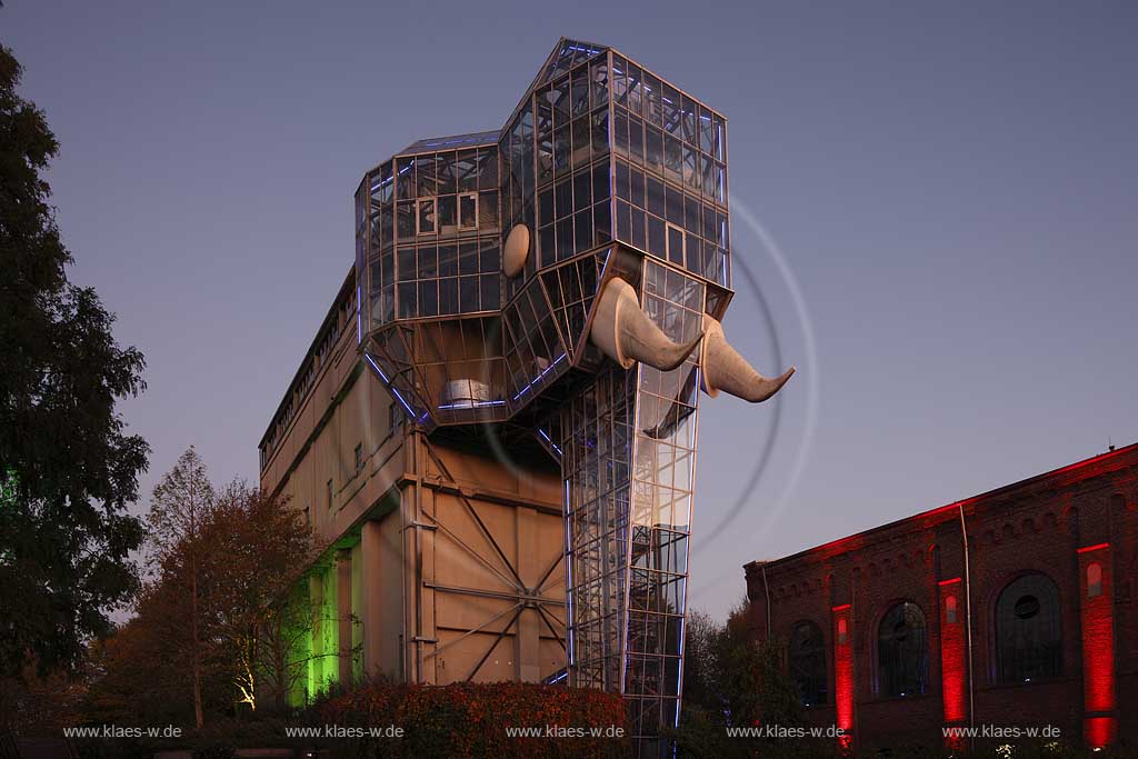 Hamm Maximilianpark waehrend Herbstleuchten zur blauen Stunde mit Illumination, illuminierter Glaselefant von Kuenstler und Architekt Horst Relleke. Der Glaselefant ist Wahrzeichen der Stadt und gleichzeitig als das weltweit groesste Gebaeude in Tiergestalt im Guinessbuch der Rekorde eingetragen; The "Glaselefant" in the Maximilianpark Hamm is not only a landmark, but also an architectural highlight of the city of Hamm. It is registered in the Guinness book of records as the worlds largest building in shape of an animal