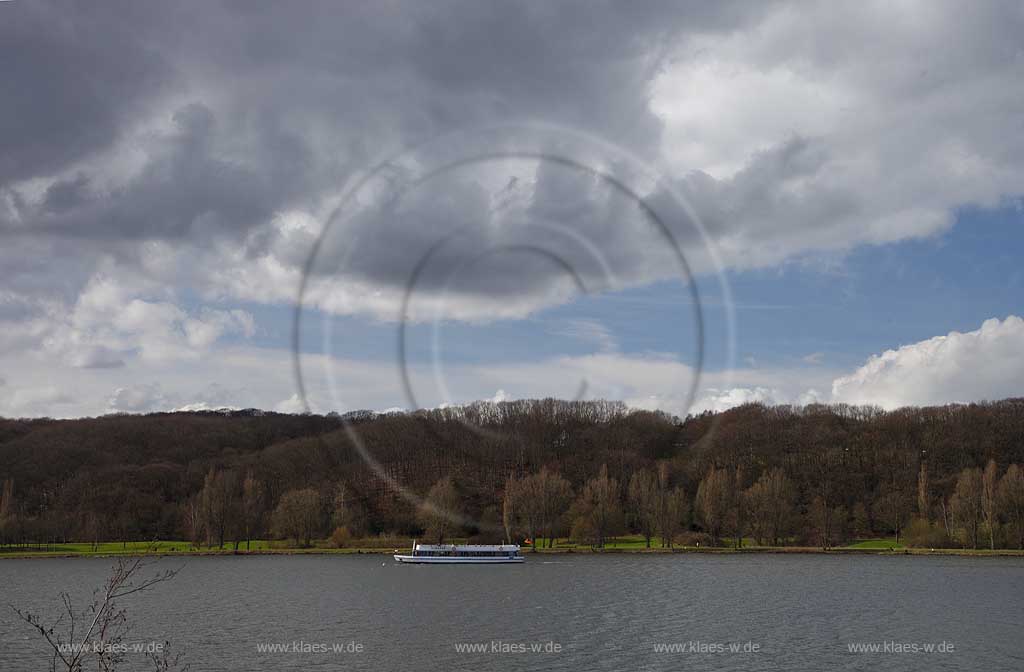 Kemnader See mit Wokenstimmung, dunkle Wolken und Fahrgastschiff MS Kemnade im Fruehling mit kahlen Baeumen; Lake Kemnade with ship MS Kamnade and dark clouds impressiom